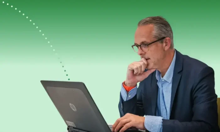 Pharma marketing leader reviewing campaign results on a laptop