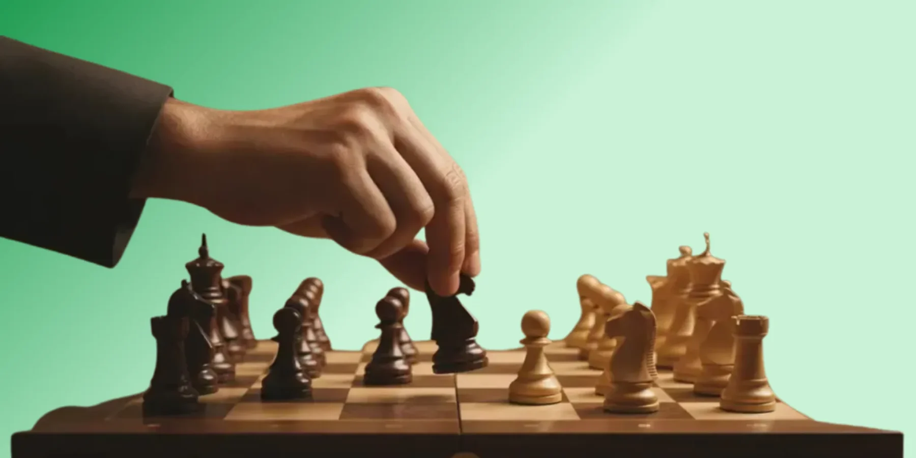 Close-up of a hand moving a chess knight to illustrate next best action strategy