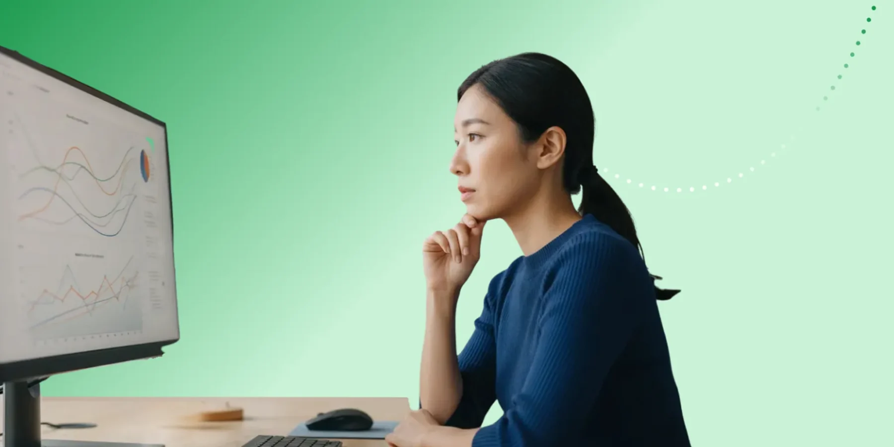 Early-30s woman of color in a business-casual analytics role reviewing pharma engagement charts on a digital dashboard.